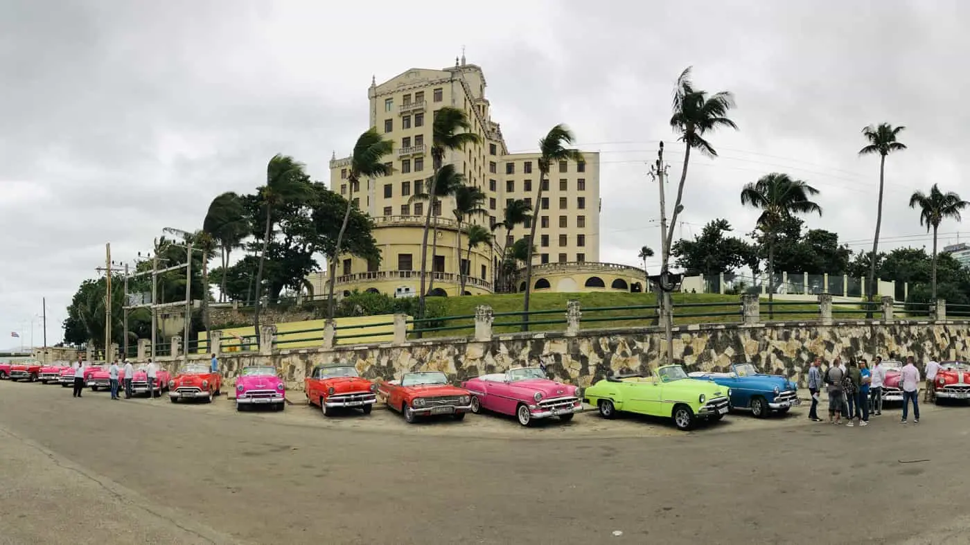 Old cars parked outside the Cuban National Hotel